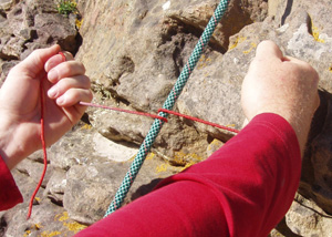 A short (30cm) piece of thin (2-3mm) nylon cord can cut a loaded rope in just 3 seconds