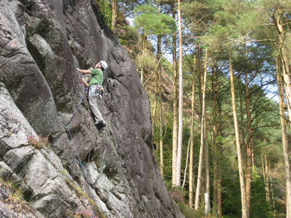 Stephen Reid under the overlap and about to break right on the first ascent of the excellent Corwar Wall.