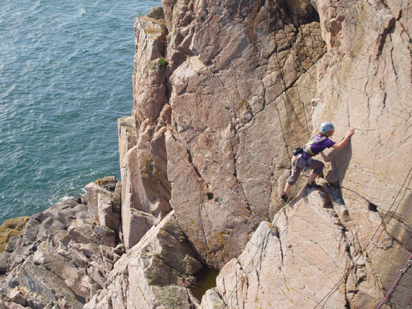 Graeme leading the delicate final moves of "The Barricades of Heaven, HVS 5a *** on the Pink Slab.