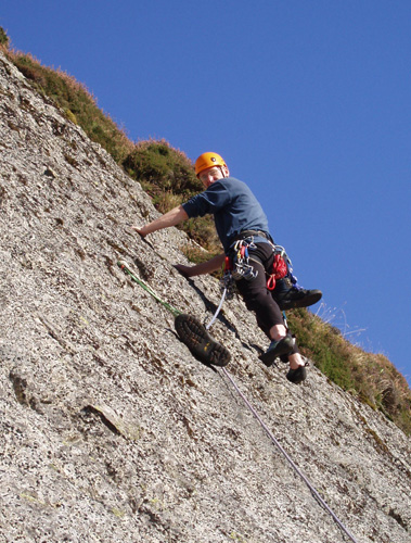 Climbing on the ramp slabs, note the unusual runner - a "draped" sling weighted with a boot..