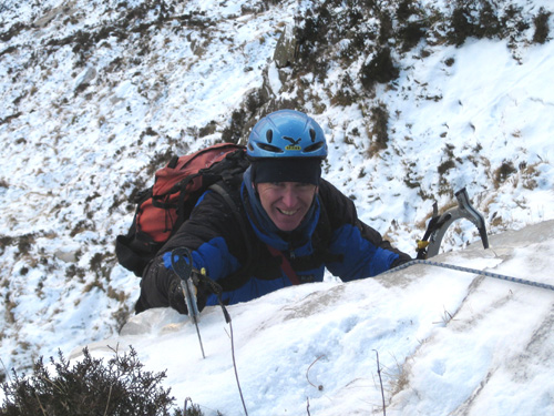John Biggar reaching the mid-way belay on Kyle Gully, February 2010