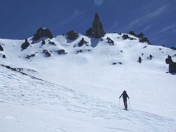 Skinning up towards the rock pinnacle of El Soldado, above Las Leas, 